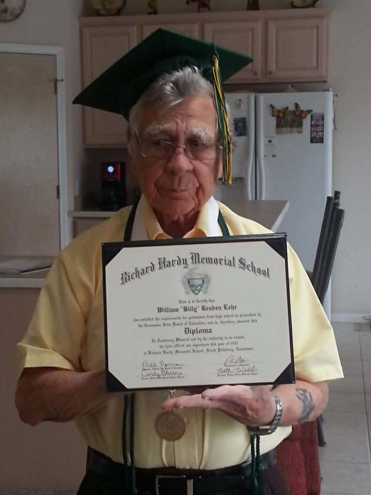 William Reuben Lehr in graduation cap holding his RHMS honorary diploma, 2013